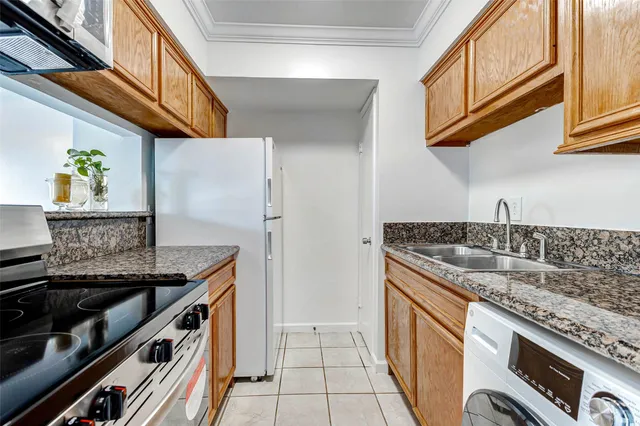 a kitchen with stainless steel appliances granite countertop a sink and a stove