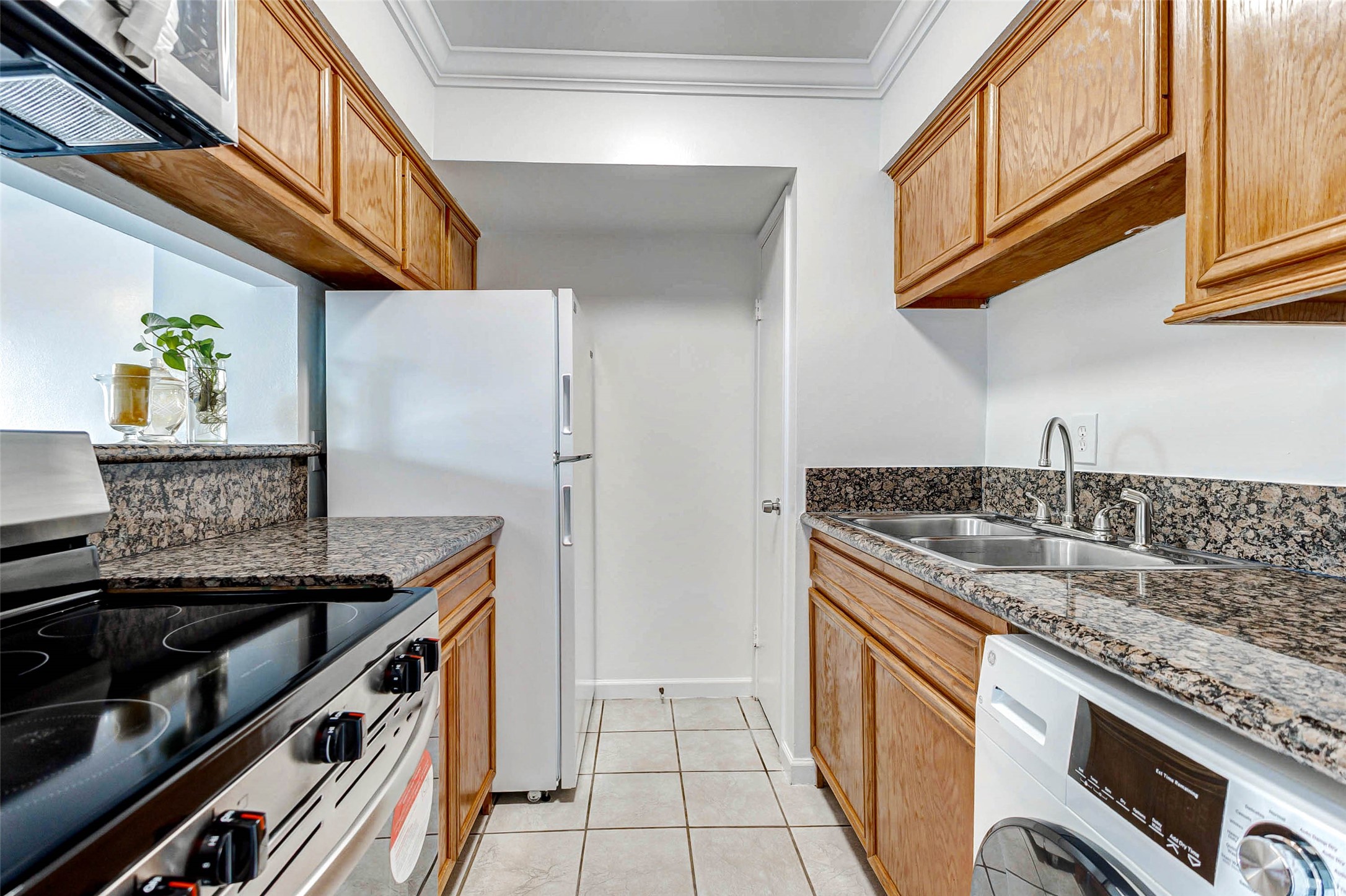 6402 Del Monte Drive, Unit 65 Houston, TX 77057 - Photo 8 of 21 a kitchen with stainless steel appliances granite countertop a sink and a stove