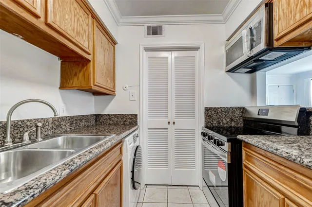 a kitchen with stainless steel appliances granite countertop a sink stove and cabinets