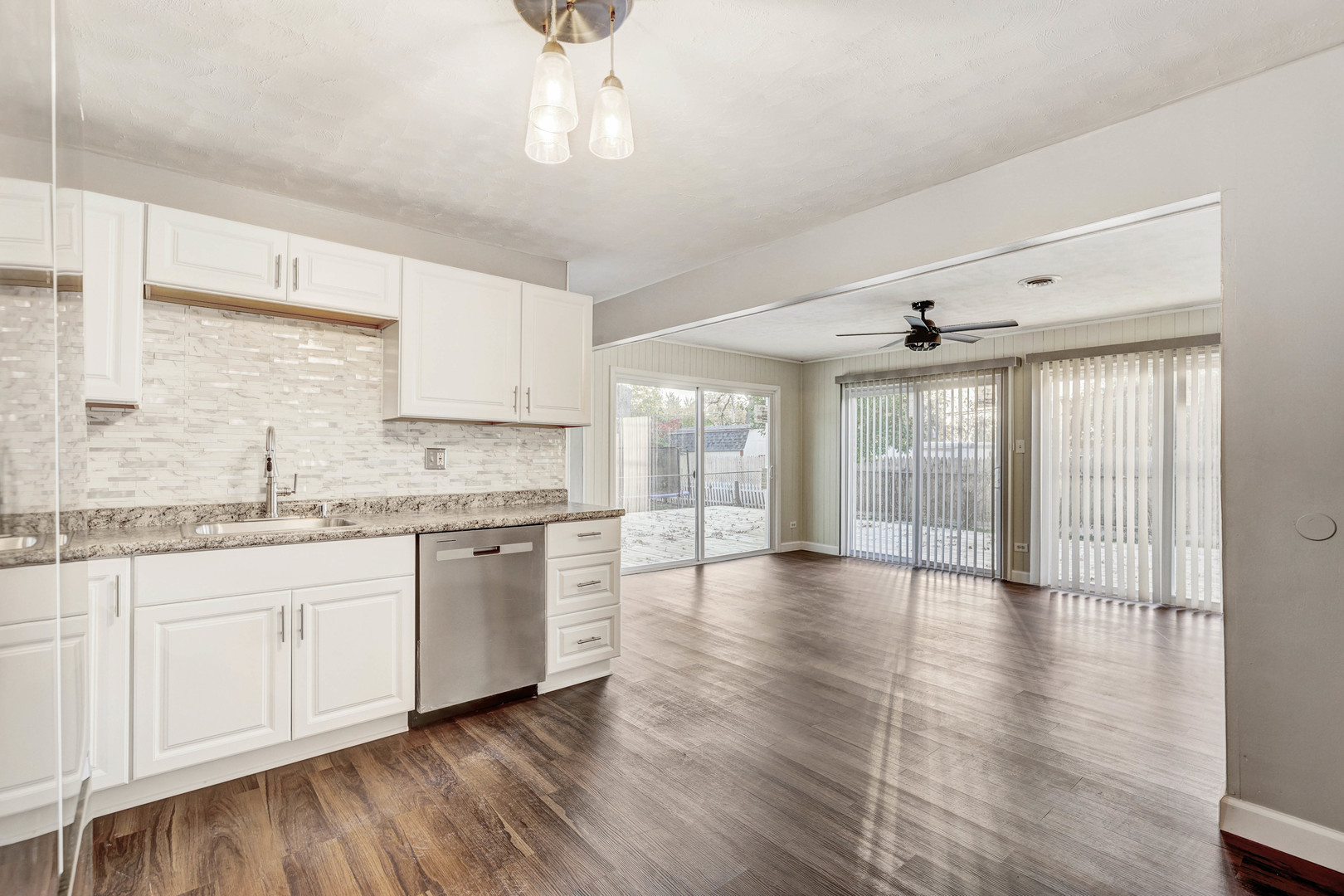 8 Timber Trail Streamwood, IL 60107 - Photo 14 of 27 a large kitchen with granite countertop a stove and white cabinets with wooden floor