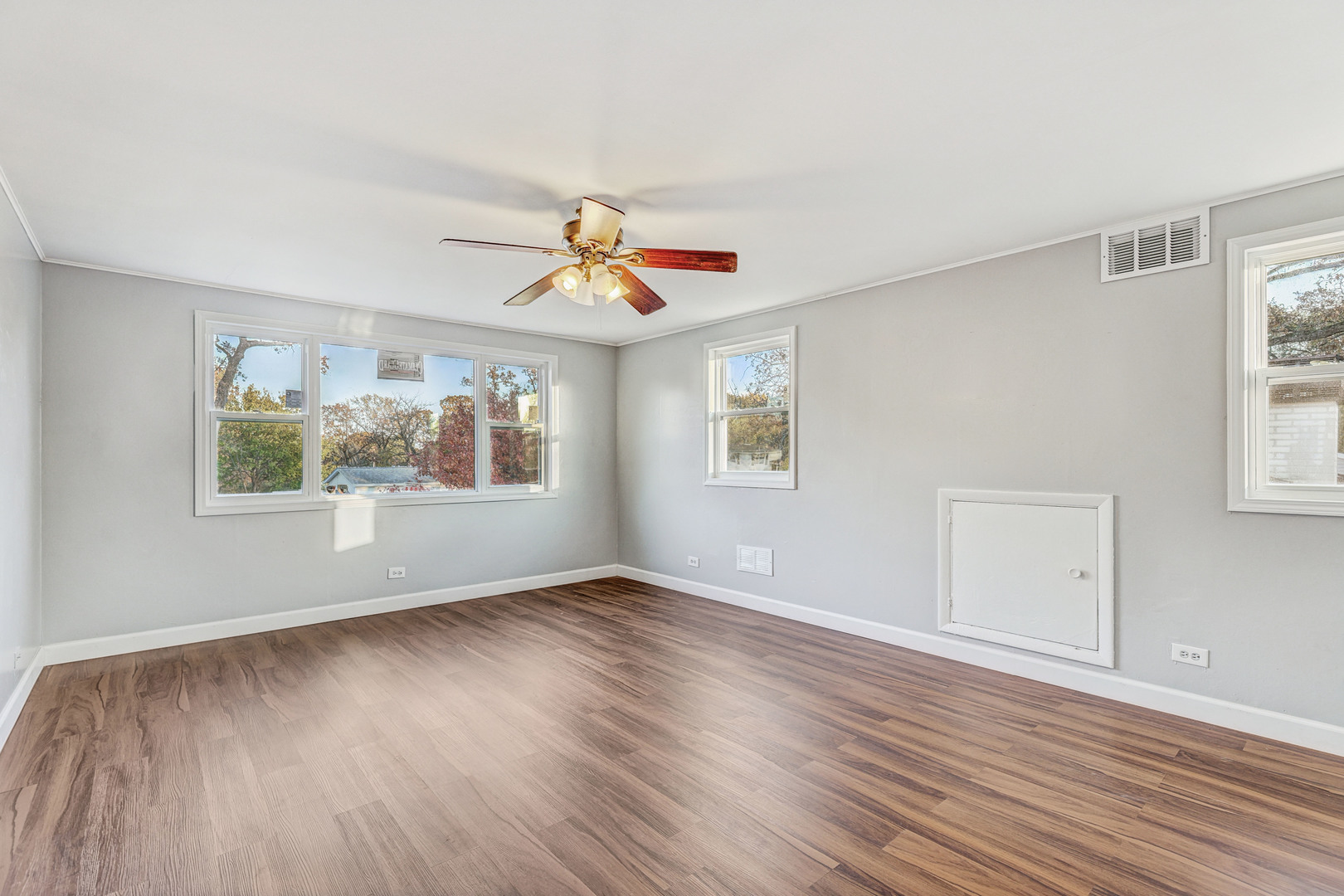 8 Timber Trail Streamwood, IL 60107 - Photo 22 of 27 a view of an empty room with a window and wooden floor