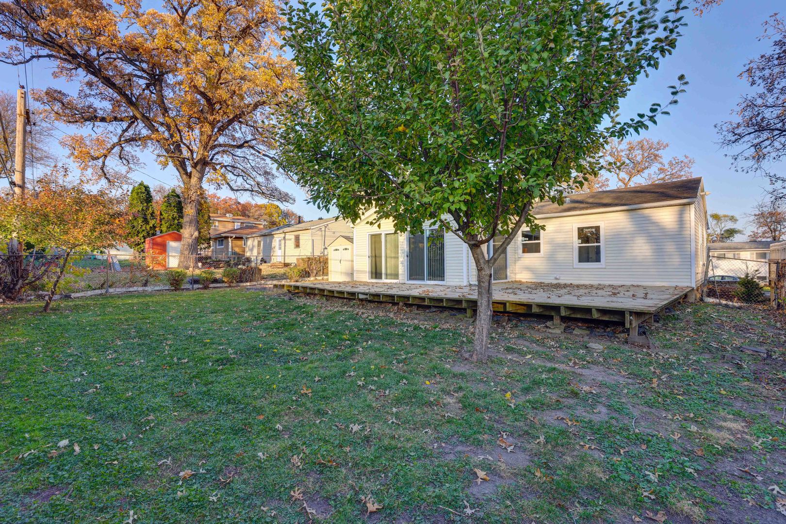 8 Timber Trail Streamwood, IL 60107 - Photo 27 of 27 a view of a backyard with wooden fence and large trees