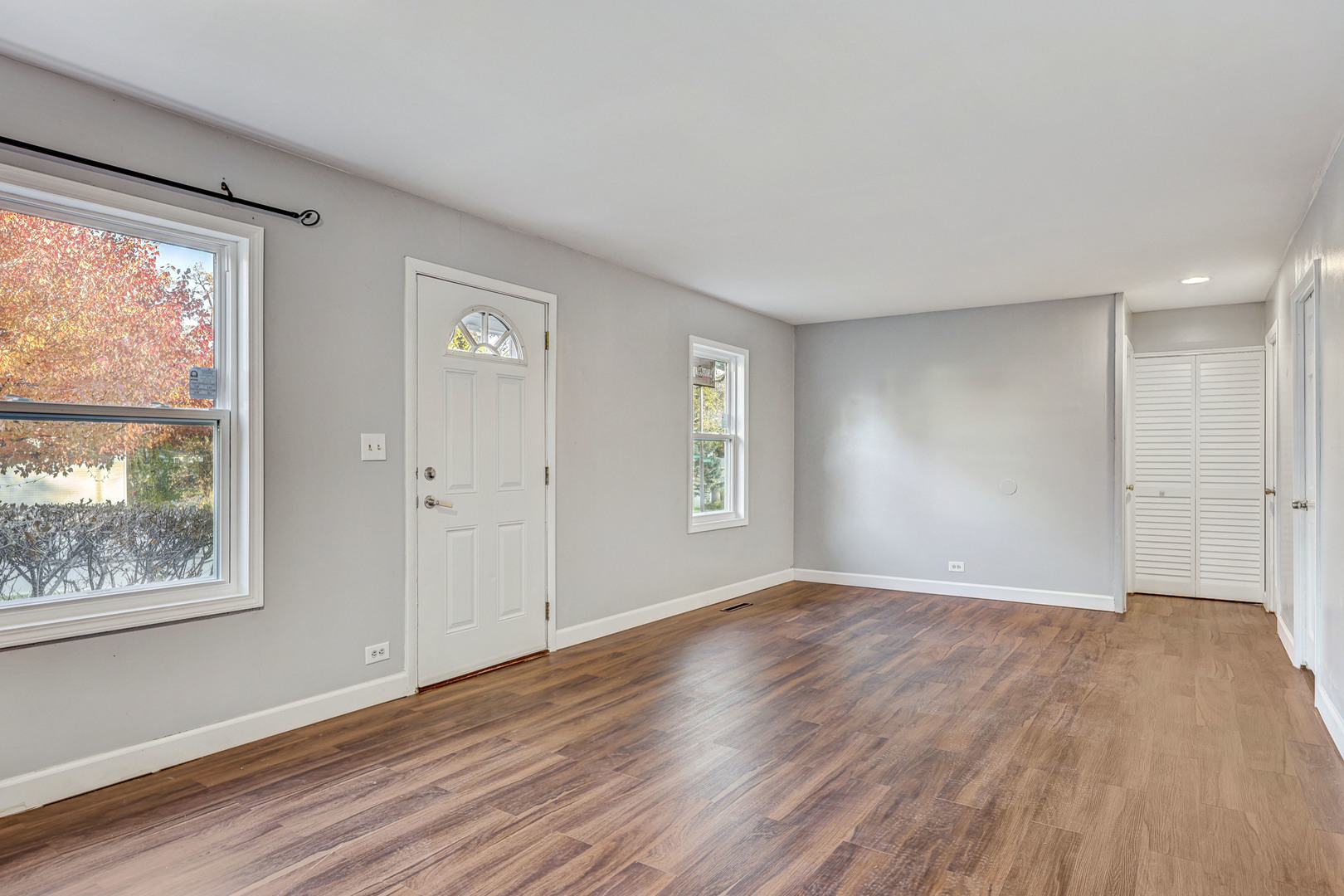 8 Timber Trail Streamwood, IL 60107 - Photo 5 of 27 a view of an empty room with wooden floor and a window