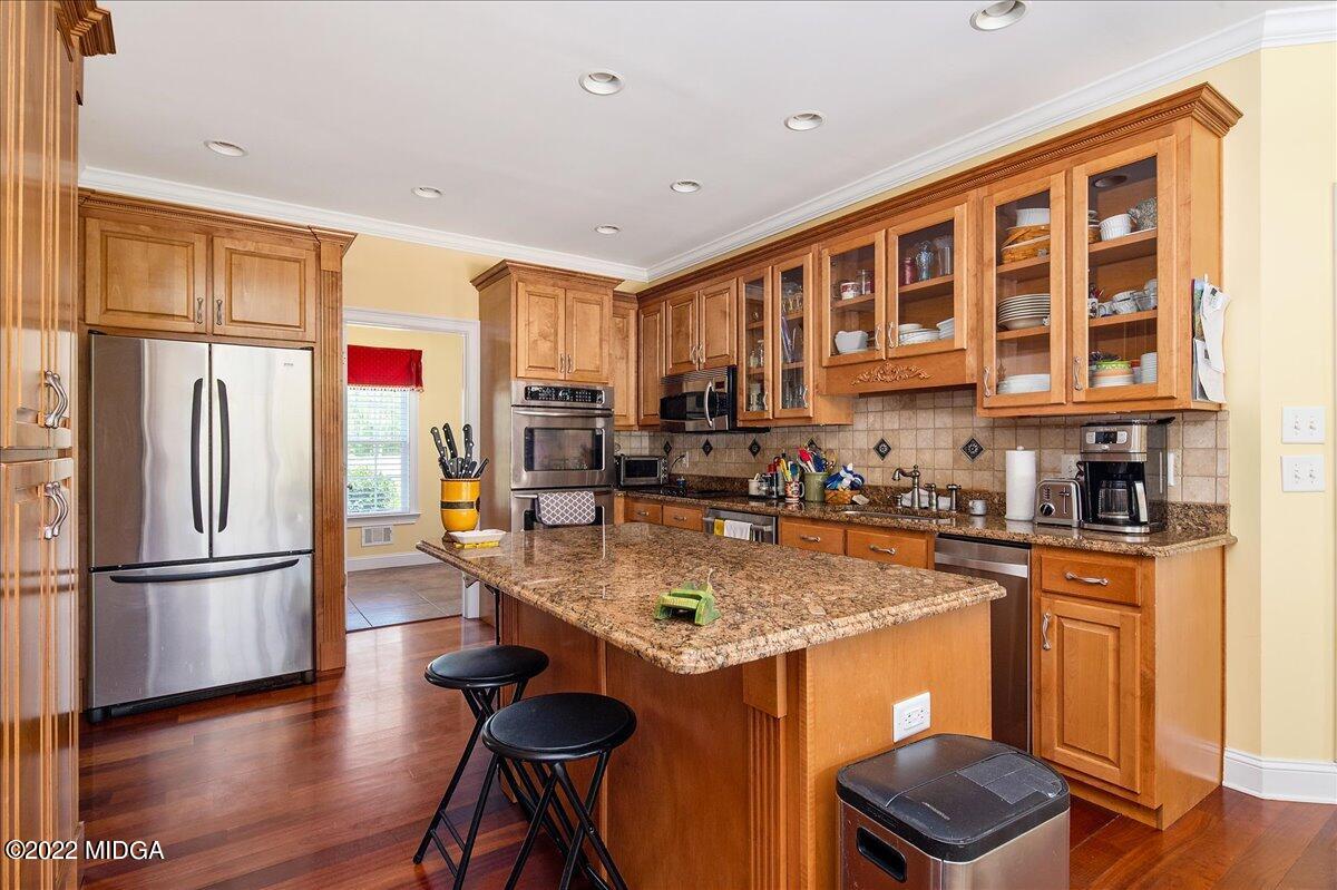 146 Lower Simmons Road Macon, GA 31220 - Photo 20 of 43 a kitchen with stainless steel appliances granite countertop a refrigerator and a stove top oven
