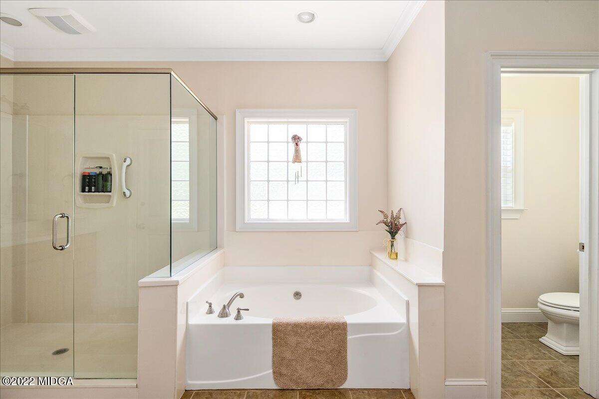 146 Lower Simmons Road Macon, GA 31220 - Photo 26 of 43 a bathroom with a bathtub and a shower