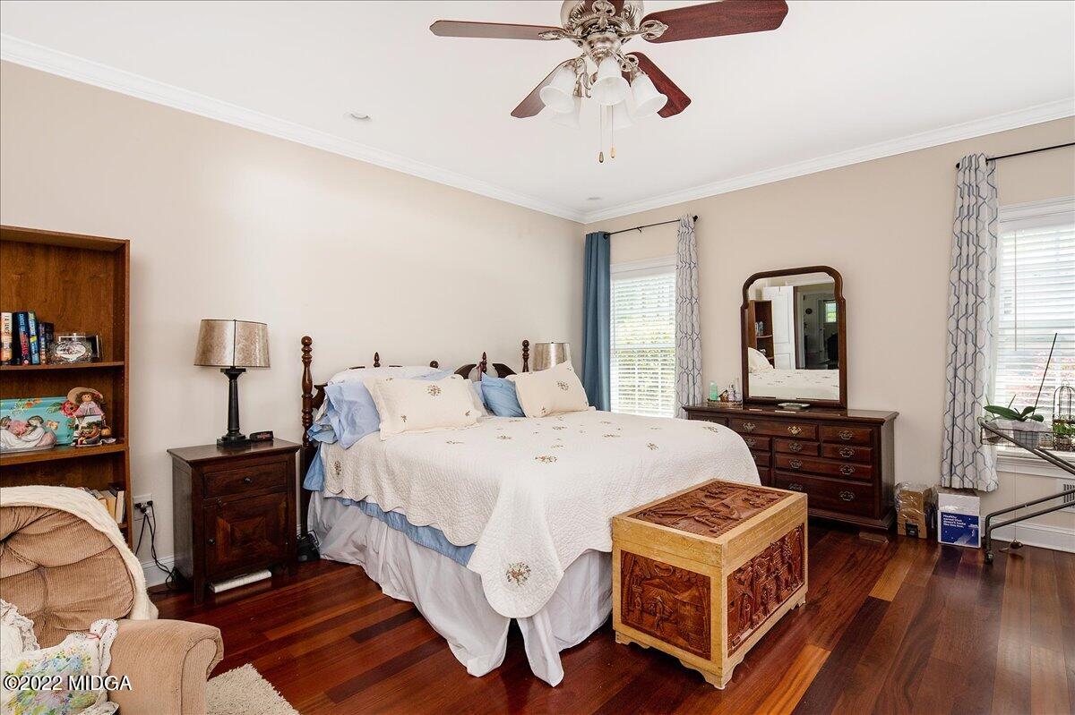 146 Lower Simmons Road Macon, GA 31220 - Photo 29 of 43 a spacious bedroom with a bed a dresser and wooden floor