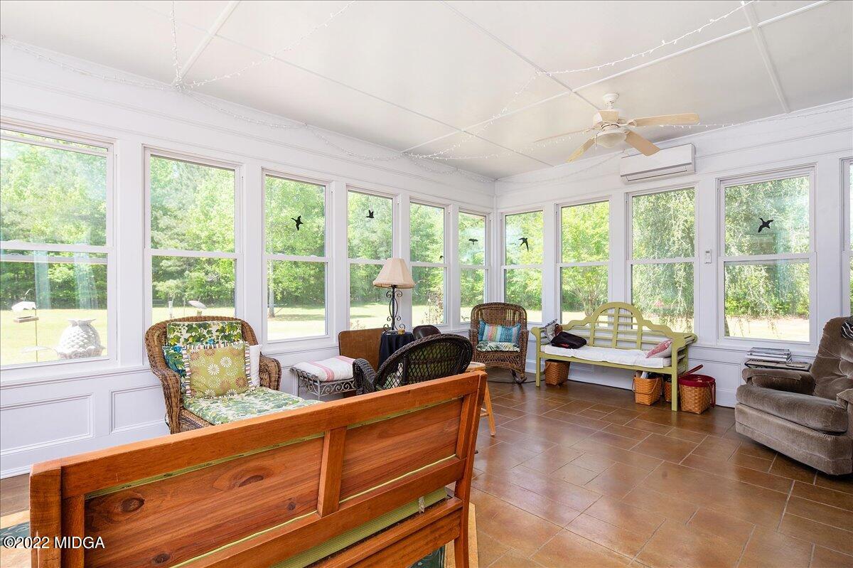 146 Lower Simmons Road Macon, GA 31220 - Photo 30 of 43 a living room with furniture and floor to ceiling windows