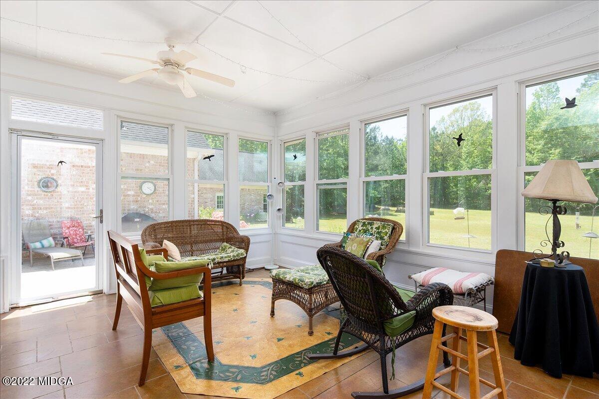 146 Lower Simmons Road Macon, GA 31220 - Photo 31 of 43 a living room with furniture and a floor to ceiling window