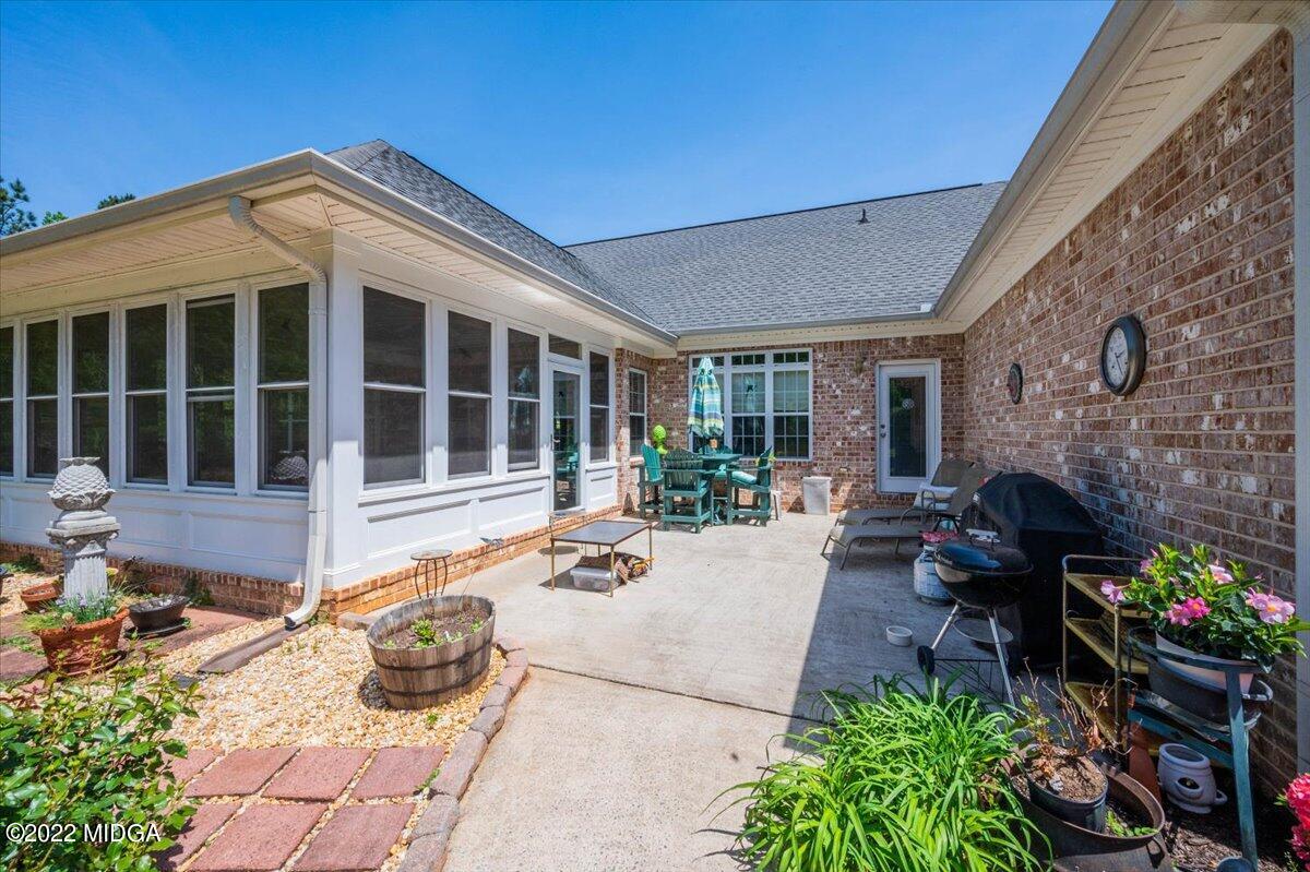 146 Lower Simmons Road Macon, GA 31220 - Photo 36 of 43 a view of a porch with furniture and floor to ceiling window
