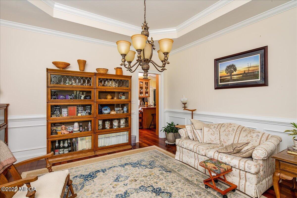 146 Lower Simmons Road Macon, GA 31220 - Photo 8 of 43 a living room with furniture a rug and a book shelf
