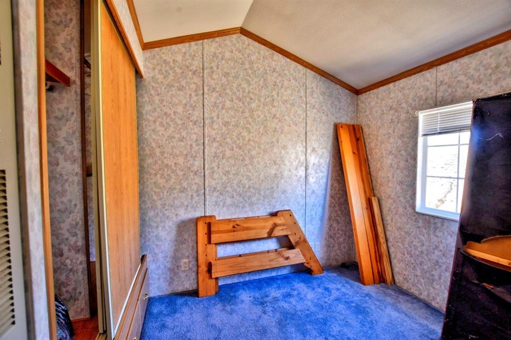 631 Murphy Road Como, CO 80432 - Photo 9 of 21 a view of an empty room with wooden floor and a window