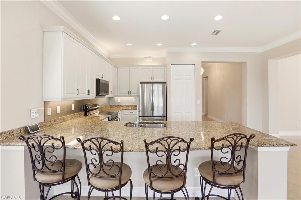 11505 Summerview Way Fort Myers, FL 33913 - Photo 12 of 50 a kitchen with stainless steel appliances granite countertop a table and chairs