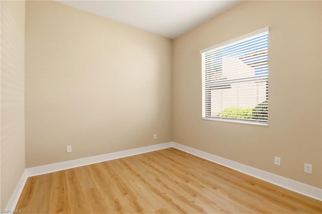 11505 Summerview Way Fort Myers, FL 33913 - Photo 22 of 50 a view of an empty room with wooden floor and a window