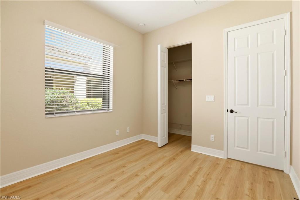 11505 Summerview Way Fort Myers, FL 33913 - Photo 26 of 50 a view of an empty room with wooden floor and a window