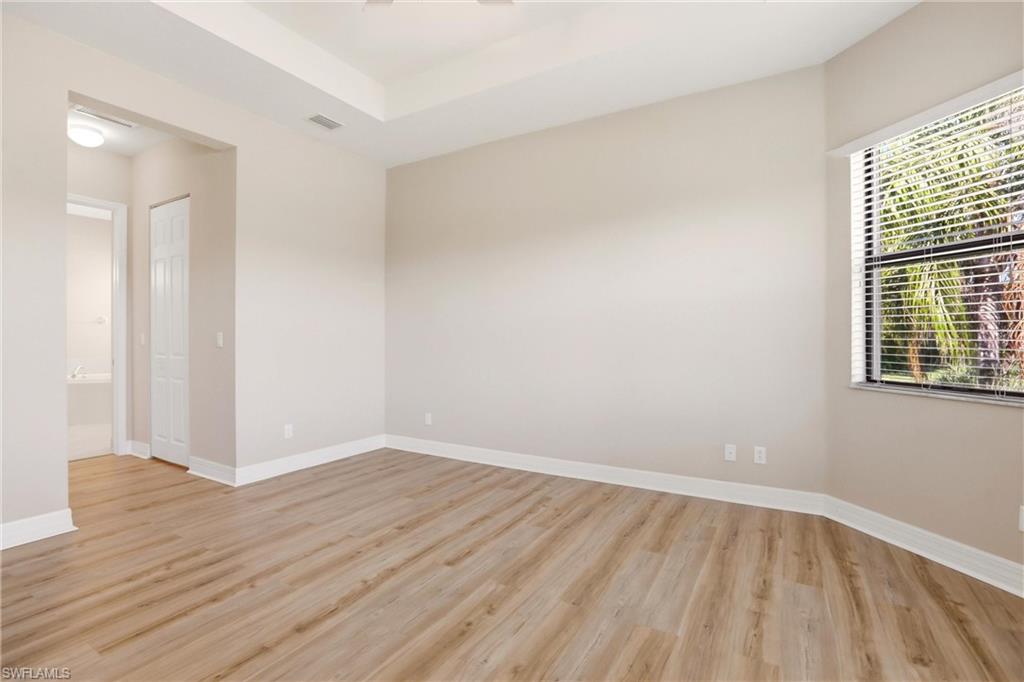 11505 Summerview Way Fort Myers, FL 33913 - Photo 28 of 50 a view of an empty room with wooden floor and a window