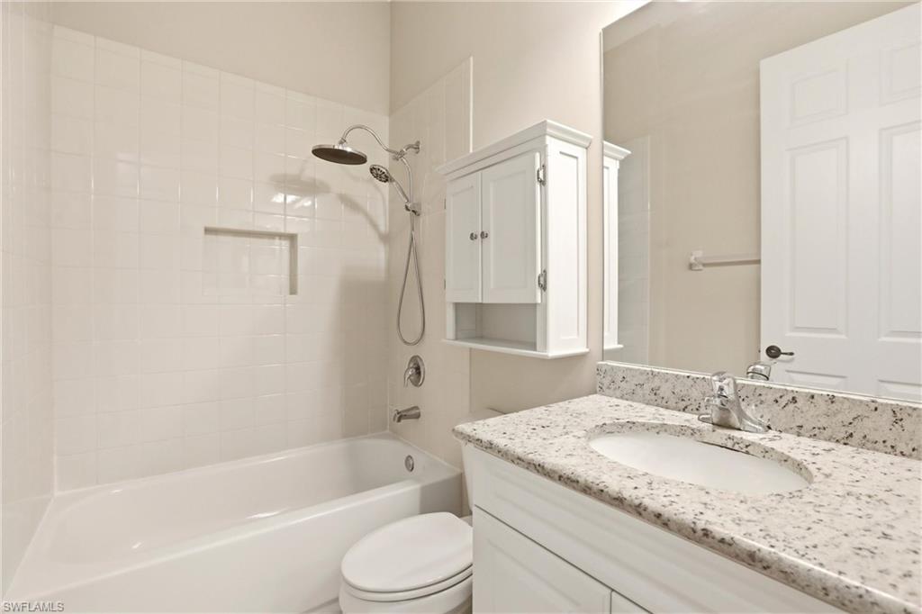 11505 Summerview Way Fort Myers, FL 33913 - Photo 31 of 50 a bathroom with a granite countertop sink toilet and shower