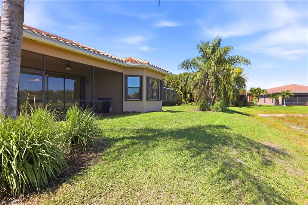 11505 Summerview Way Fort Myers, FL 33913 - Photo 43 of 50 a yellow house with flower garden in front of it