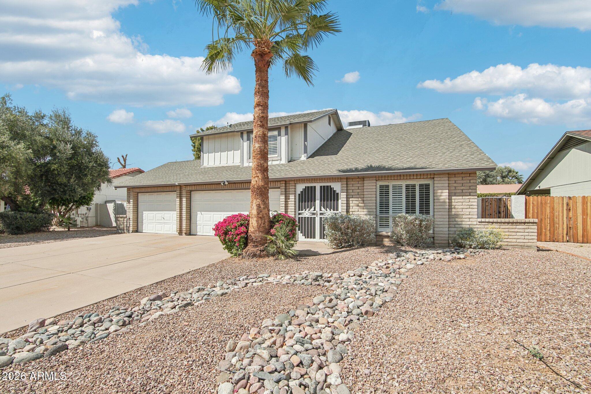 4662 East Grandview Road Phoenix, AZ 85032 - Photo 6 of 42 a front view of a house with a yard and potted plants