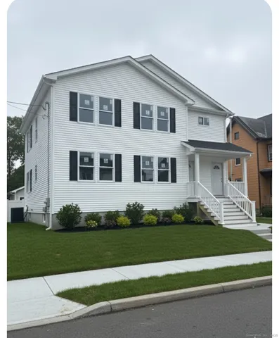 a front view of a house with a garden