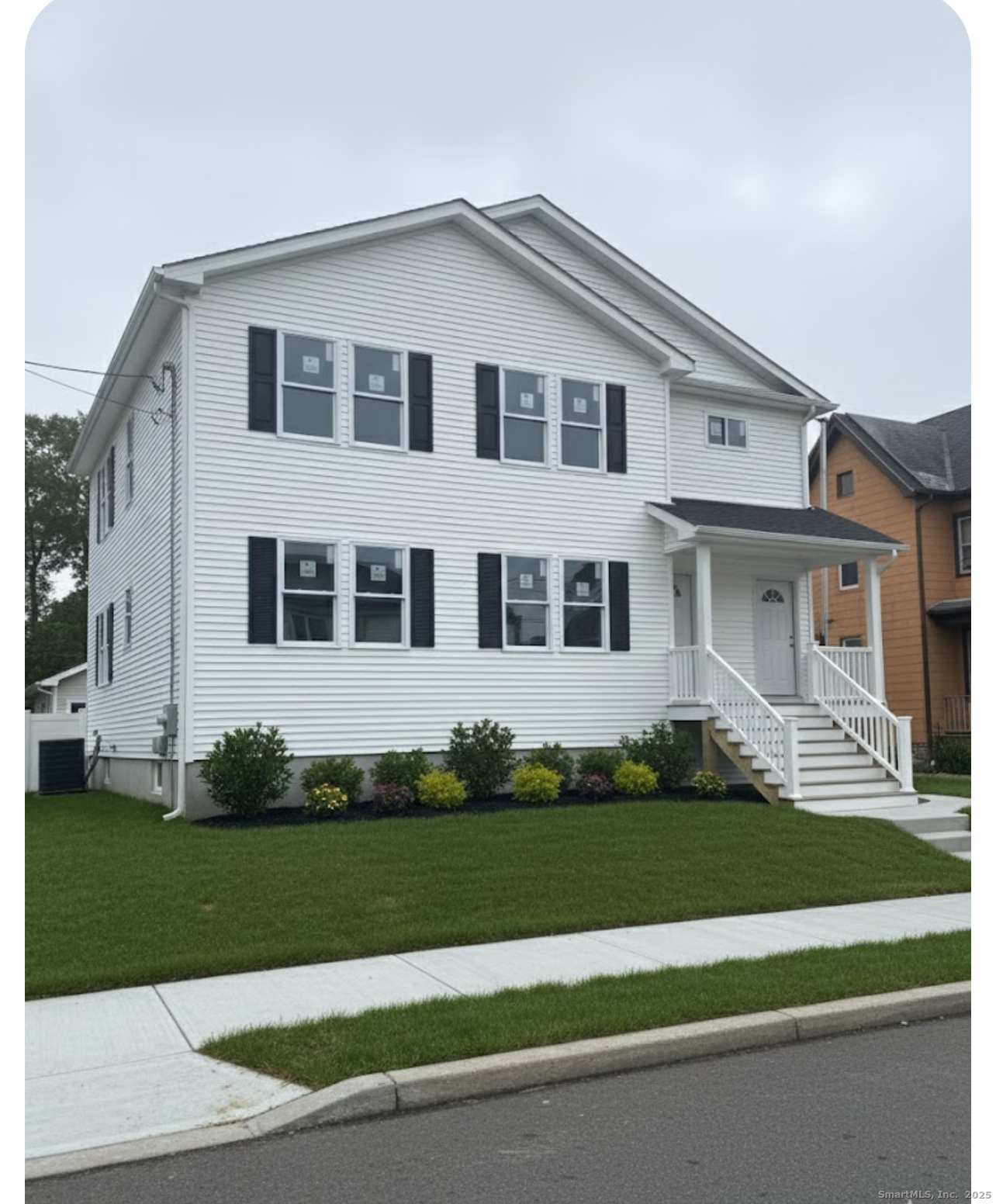 1218 Kossuth Street Bridgeport, CT 06608 - Photo 2 of 8 a front view of a house with a garden