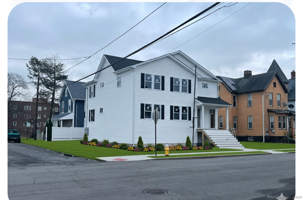 1218 Kossuth Street Bridgeport, CT 06608 - Photo 3 of 8 a front view of a house with a yard
