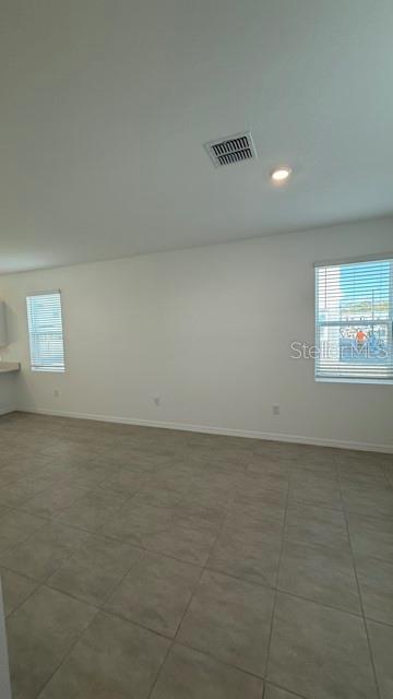 2957 Skyline Loop Kissimmee, FL 34758 - Photo 8 of 23 a view of an empty room and a window