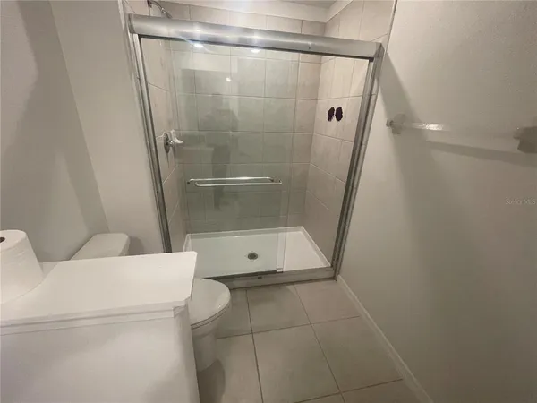 a bathroom with a shower and a sink