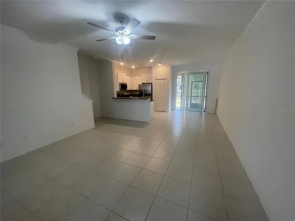a view of a livingroom with furniture and chandelier fan