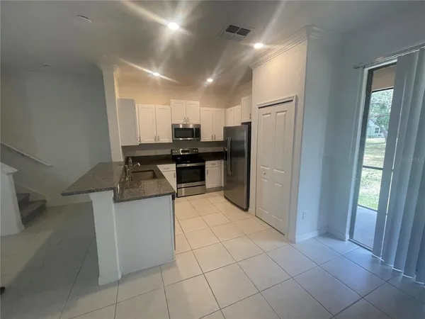 a kitchen with stainless steel appliances a refrigerator and a counter top space