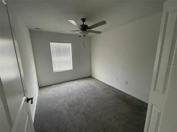 wooden floor in an empty room with a bathroom