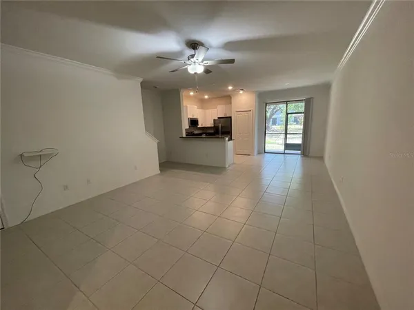 a view of a livingroom with a ceiling fan and window