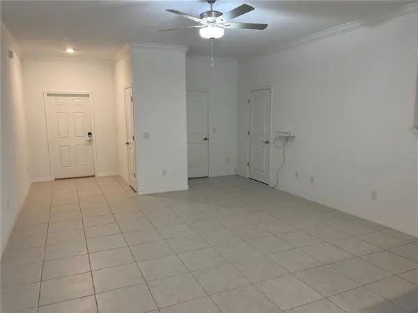 an empty room with a ceiling fan
