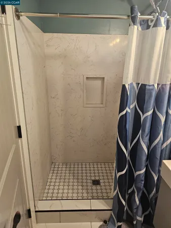 a patio with a table and chairs and potted plants