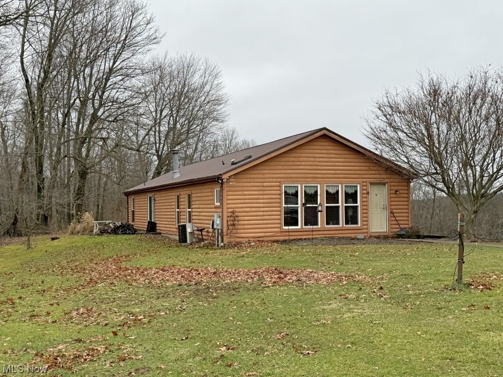 1357 Sand Ridge Road Zanesville, OH 43701 - Photo 4 of 50 Back of property with a lawn and central AC