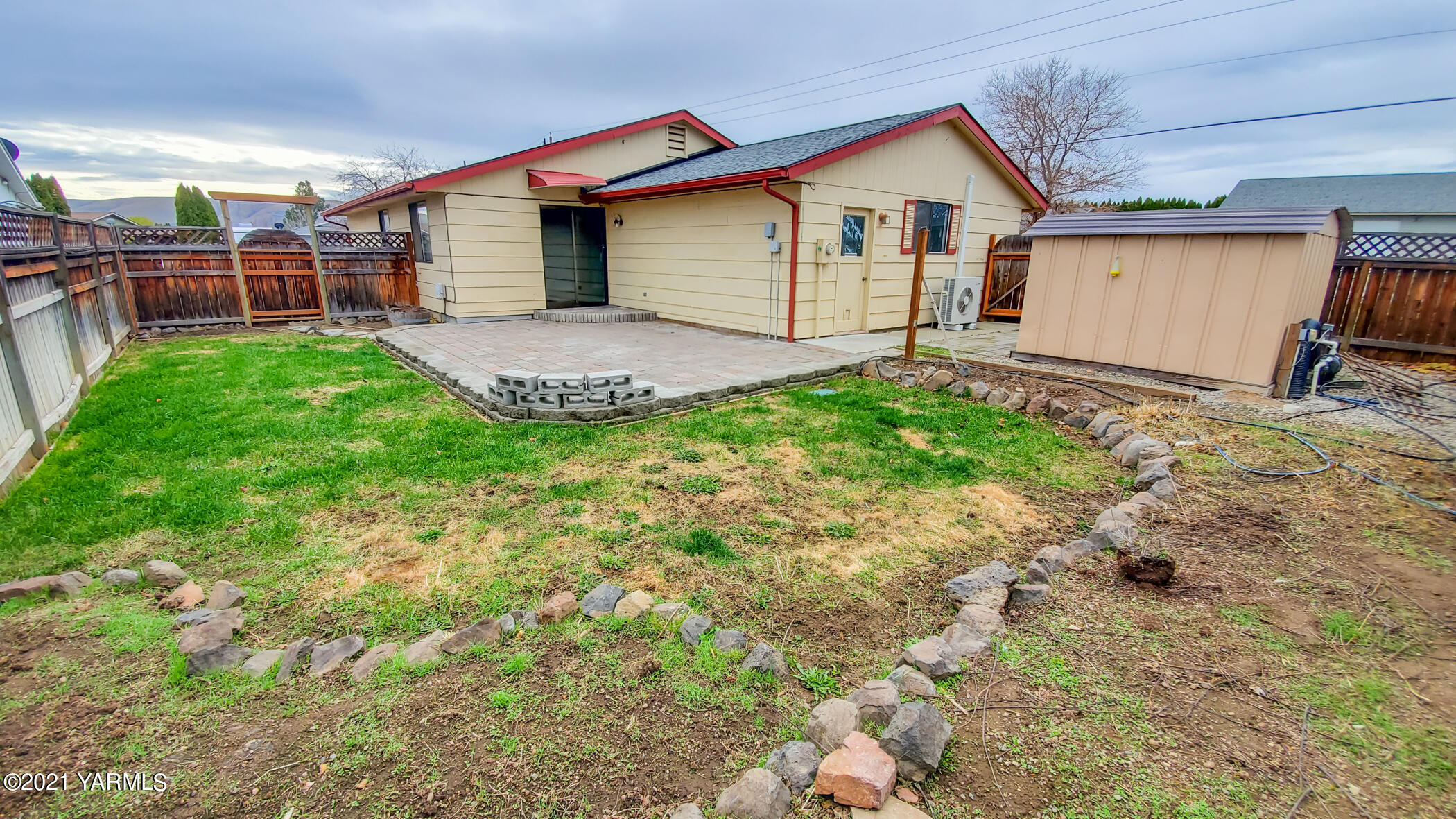 1503 South 27th Avenue Yakima, WA 98902 - Photo 23 of 26 a view of a house with a yard and wooden fence