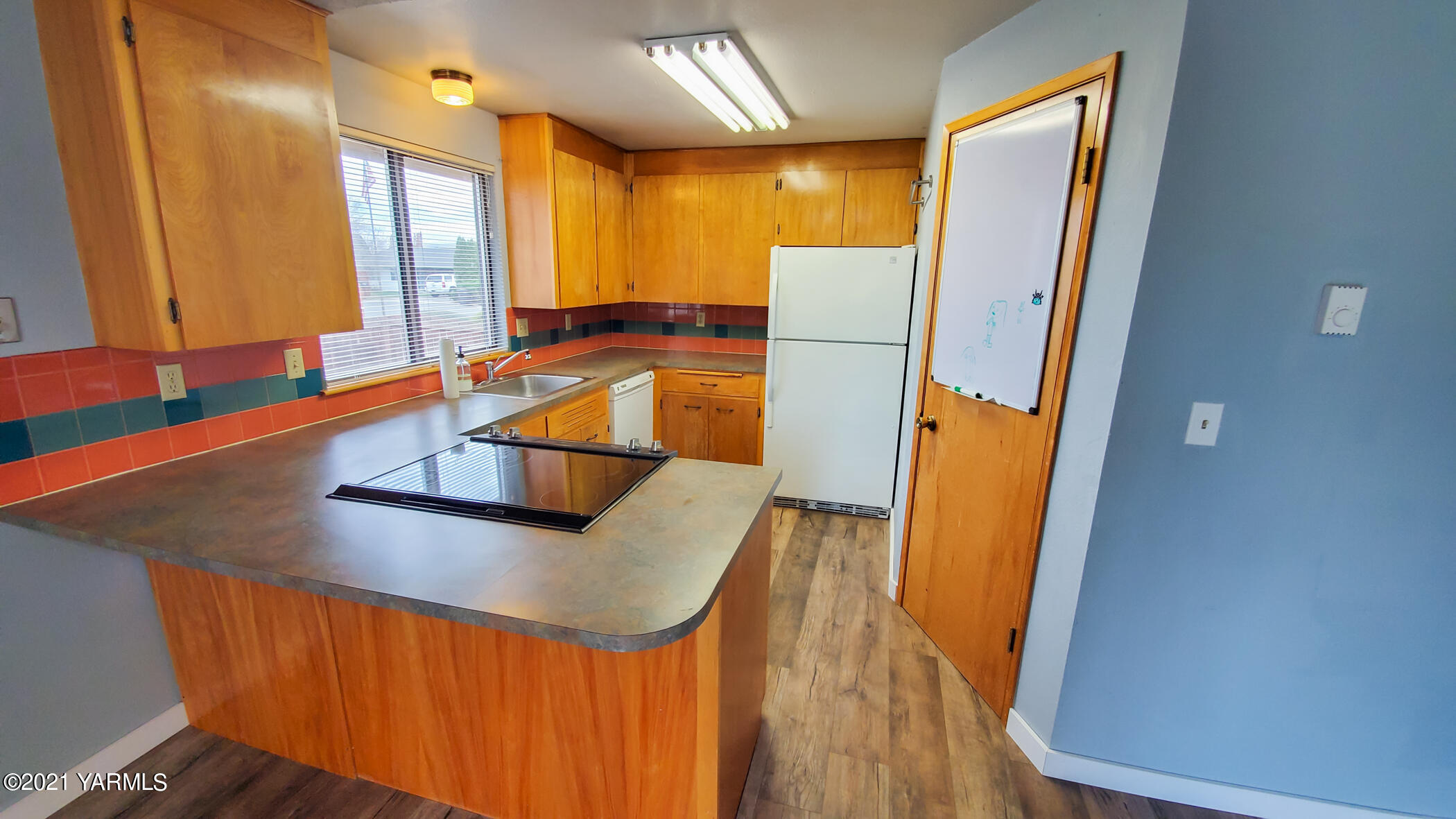 1503 South 27th Avenue Yakima, WA 98902 - Photo 9 of 26 a kitchen with stainless steel appliances granite countertop a refrigerator a sink and a stove