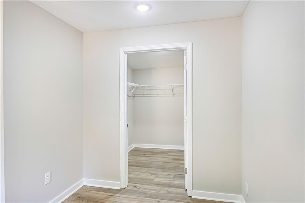 1265 Horsley Mill Road Carrollton, GA 30116 - Photo 11 of 31 a view of an empty room with wooden floor and a window