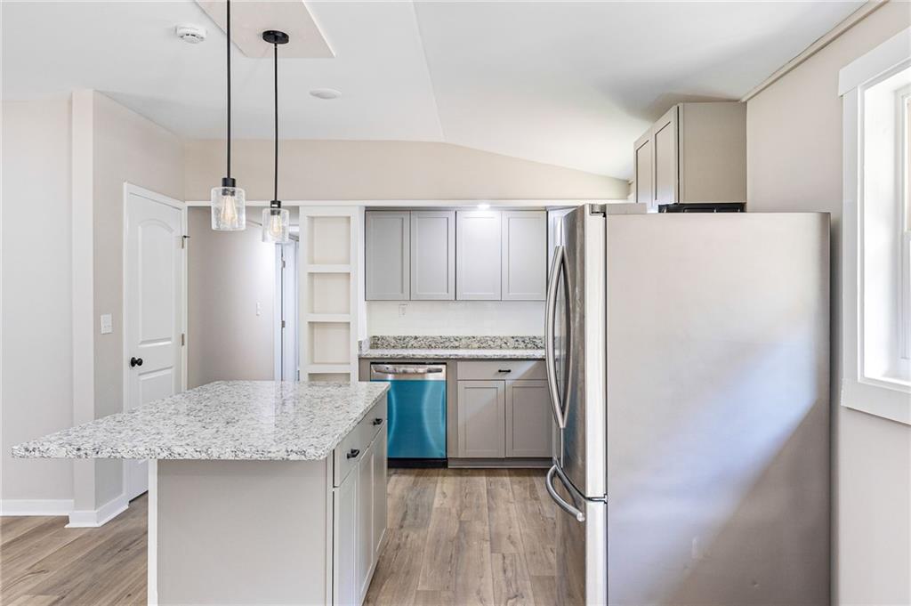 1265 Horsley Mill Road Carrollton, GA 30116 - Photo 15 of 31 a kitchen with stainless steel appliances granite countertop a refrigerator a oven and white cabinets with granite countertops