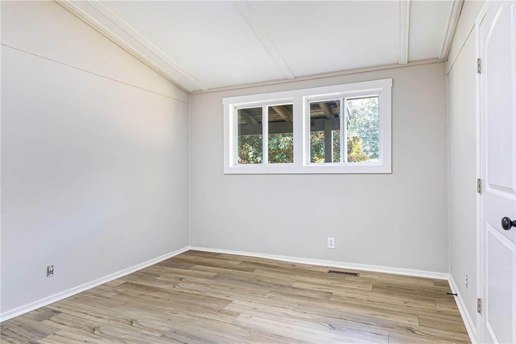 1265 Horsley Mill Road Carrollton, GA 30116 - Photo 6 of 31 an empty room with wooden floor and windows