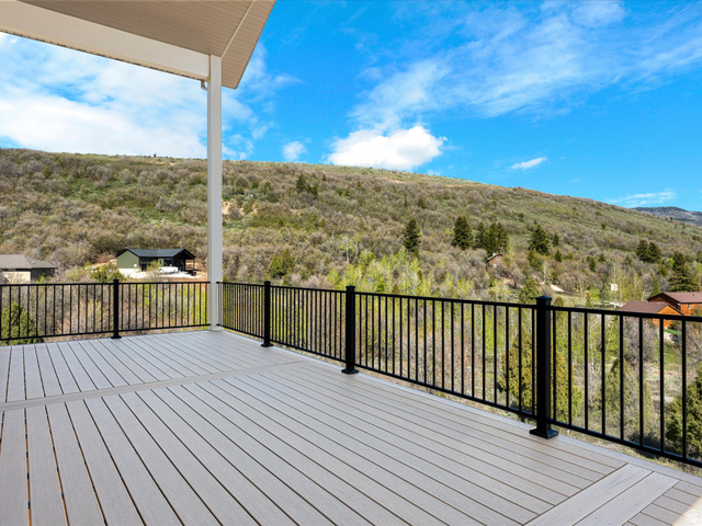1159 North Broad Hollow Road Garden City, UT 84028 - Photo 34 of 55 Expansive outdoor deck featuring composite decking and a black metal railing