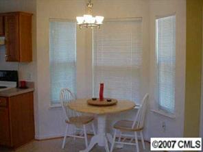 6532 Nevin Road Charlotte, NC 28262 - Photo 8 of 8 a dining room with furniture and chandelier