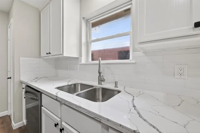 a kitchen with stainless steel appliances a stove sink microwave and cabinets
