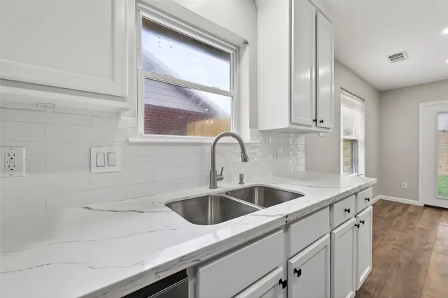 a kitchen with a sink and cabinets