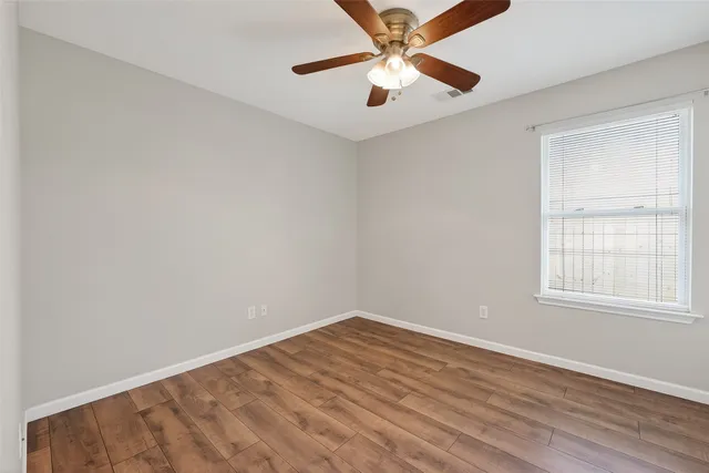 a spacious bathroom with a sink a mirror and a shower