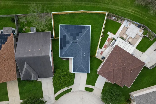 a view of a backyard with plants and a garden