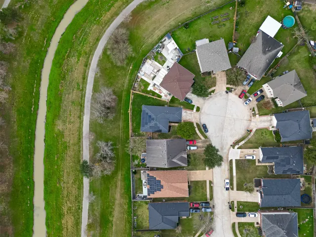 an aerial view of residential houses with outdoor space and street view