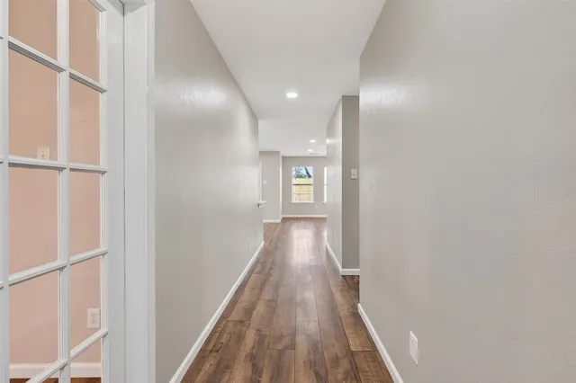a view of hallway with wooden floor