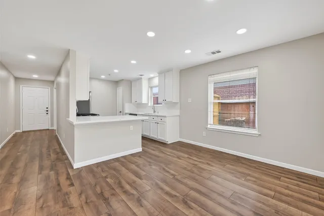 an aerial view of residential houses with outdoor space and street view