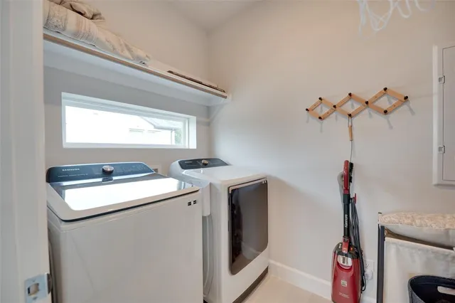 a spacious bedroom with a bed and a chandelier