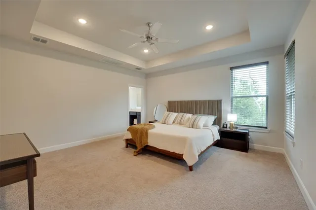 a spacious bathroom with a tub shower and a sink